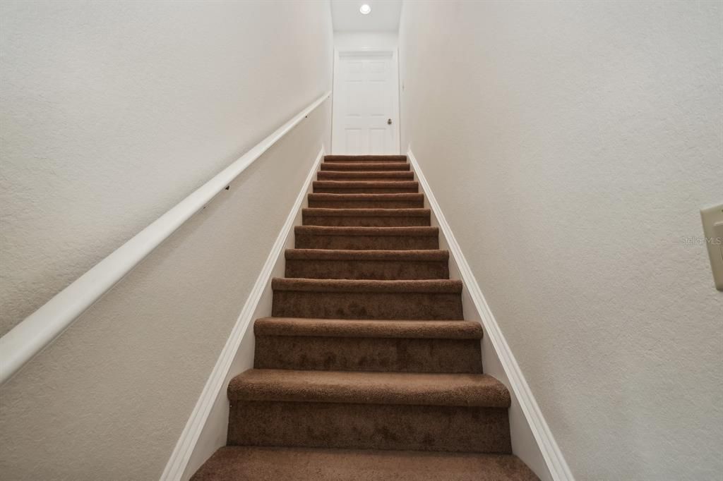 Stairs with landing at the top and door to 4th Bedroom / Bonus Room