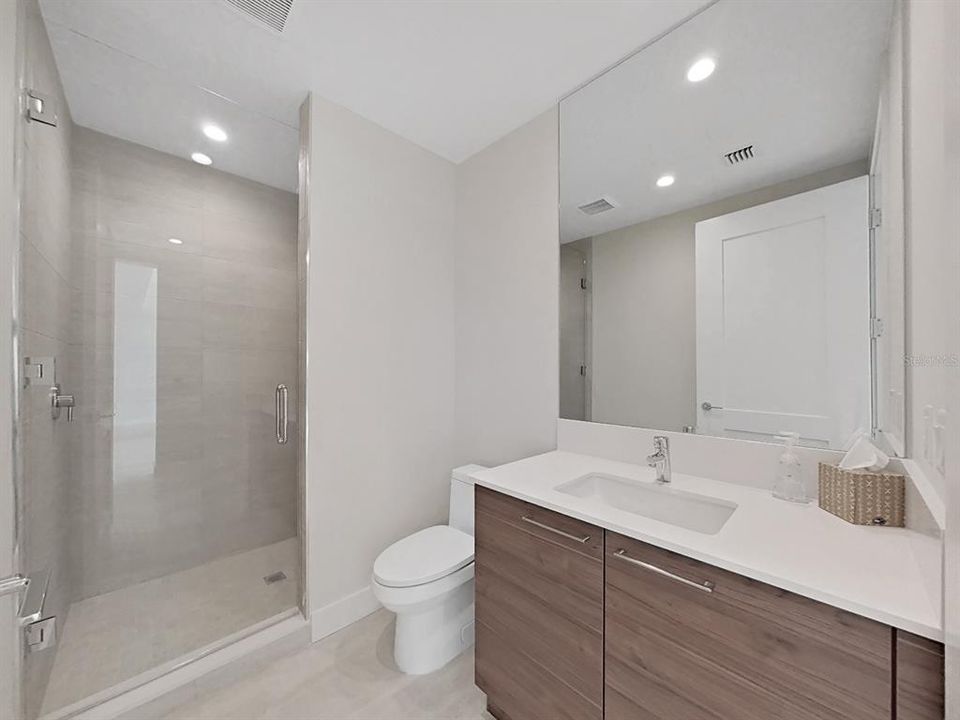 The main home bathroom with sophisticated Premium European Cabinetry and Grohe one-piece Faucet! Walk-in shower!