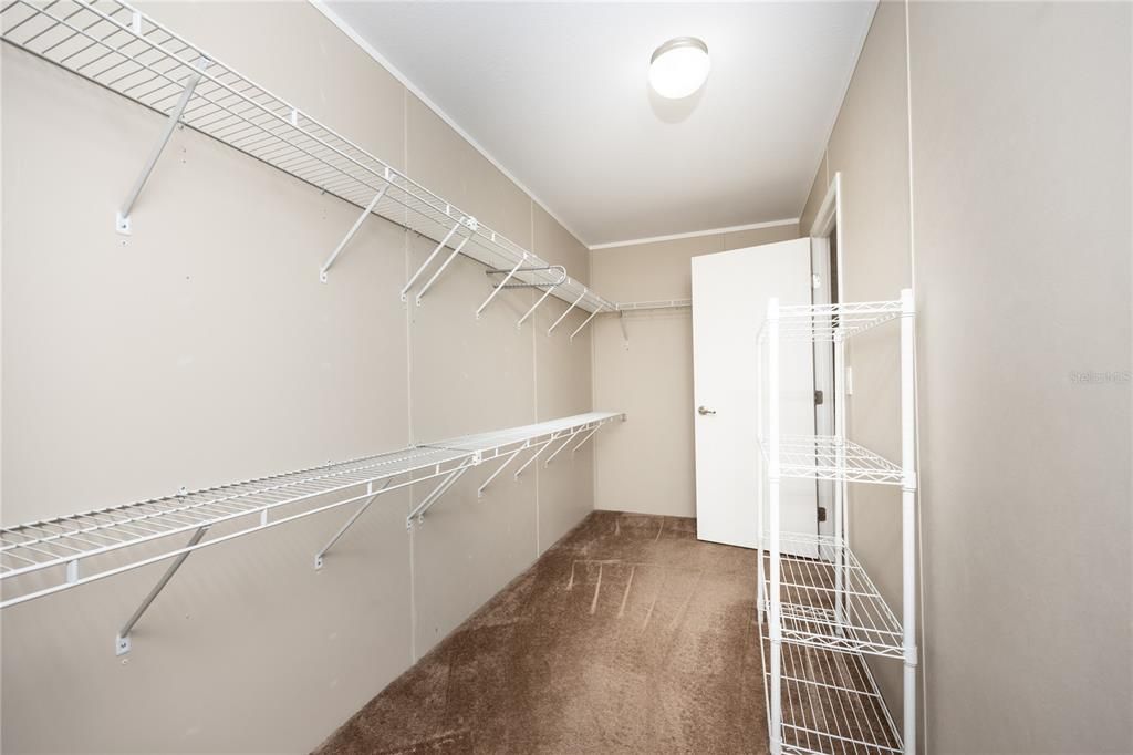 Walk in closet in the primary bedroom