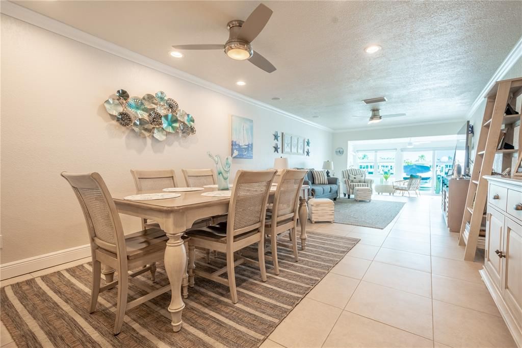 A stylish ceiling fan and large neutral porcelain tiles make for a comfortable dining experience.