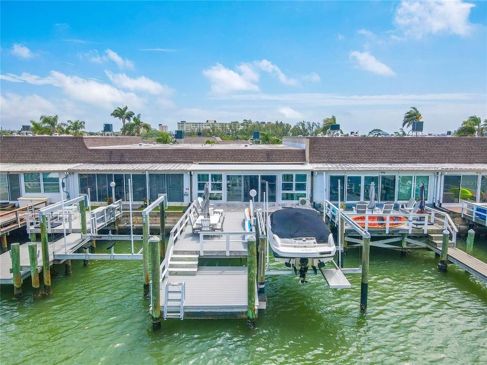 This isn't just any dock; it's a marvel of craftsmanship with a 2-level Polywood construction, guaranteed for life. Equipped with water, electricity, a formidable 9,000-pound boat lift, and kayak storage, it promises endless aquatic adventures and picturesque evenings under the sky's amber hues.
