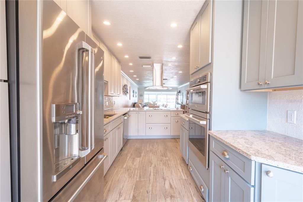 The heart of this home is undoubtedly the chef's kitchen, boasting quartz countertops, soft-close cabinets, under-counter lighting and top-of-the-line stainless appliances.