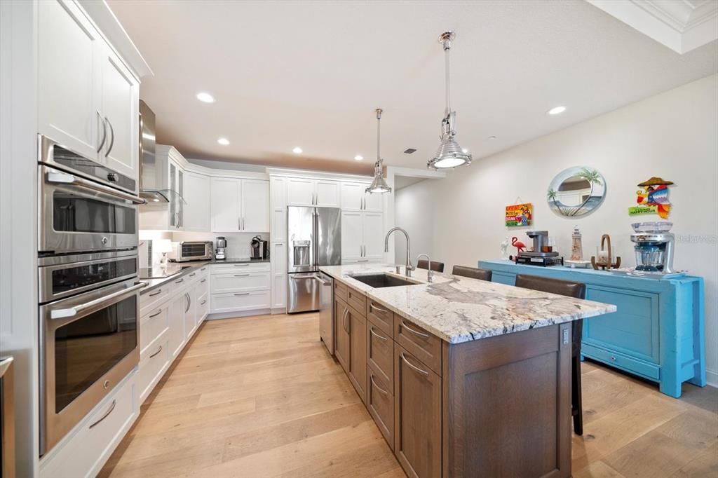 Spacious kitchen with abundant custom cabinetry for ideal storage.