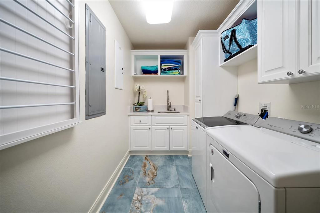 Spacious laundry area with notable storage.
