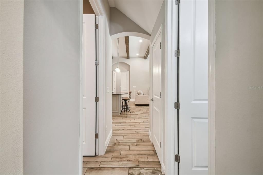 Hallway to the laundry room and 2 additional bedrooms/bathroom