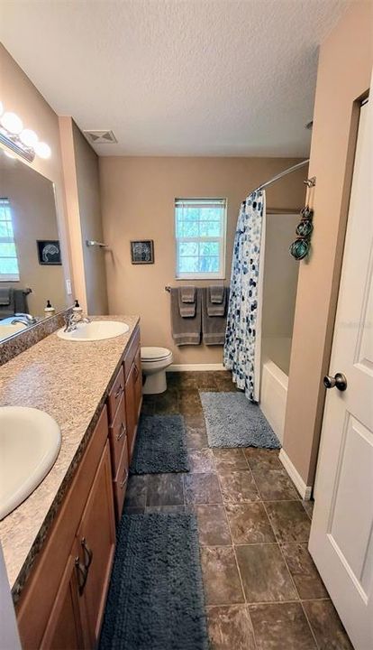 GUEST BATH - Both bathrooms have dual vanities. The master has a Walk-in Shower (no tub), and the main Hall/Guest Bath has a Tub/Shower combo