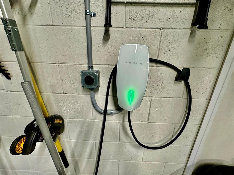 Garage includes high speed Tesla Charger as well as 220v for charging other EVs