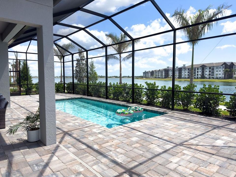 Beautiful brick paver patio around your lakeside pool.