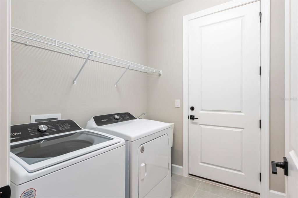 The full-sized laundry room is located along the hallway just beyond the flex room.