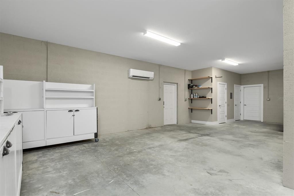3 bay garage is extra deep and includes A/C, a 1/2 bath, and connecting door to RV sized garage.