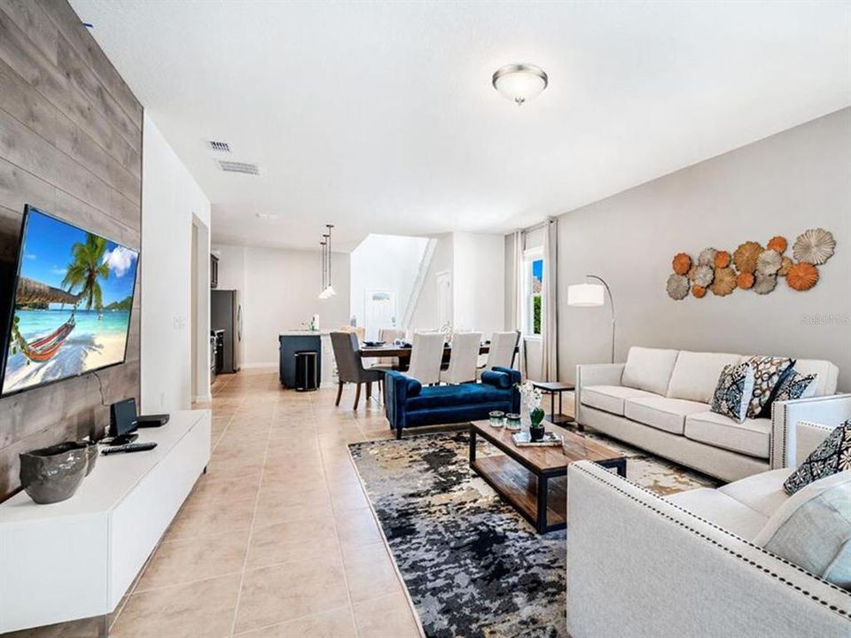 Large living room with natural light, open to dinning and kitchen.