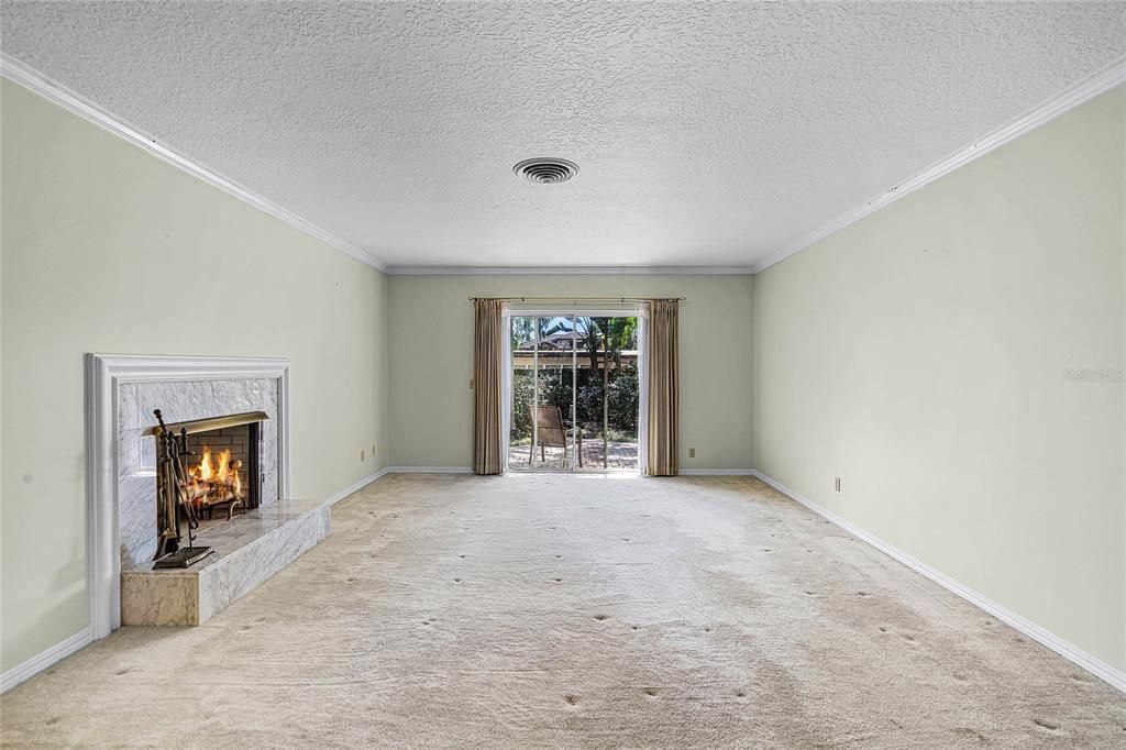 Living Room with fireplace looking at backyard