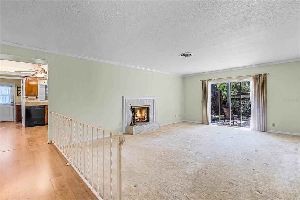 Living Room with fireplace looking into kitchen
