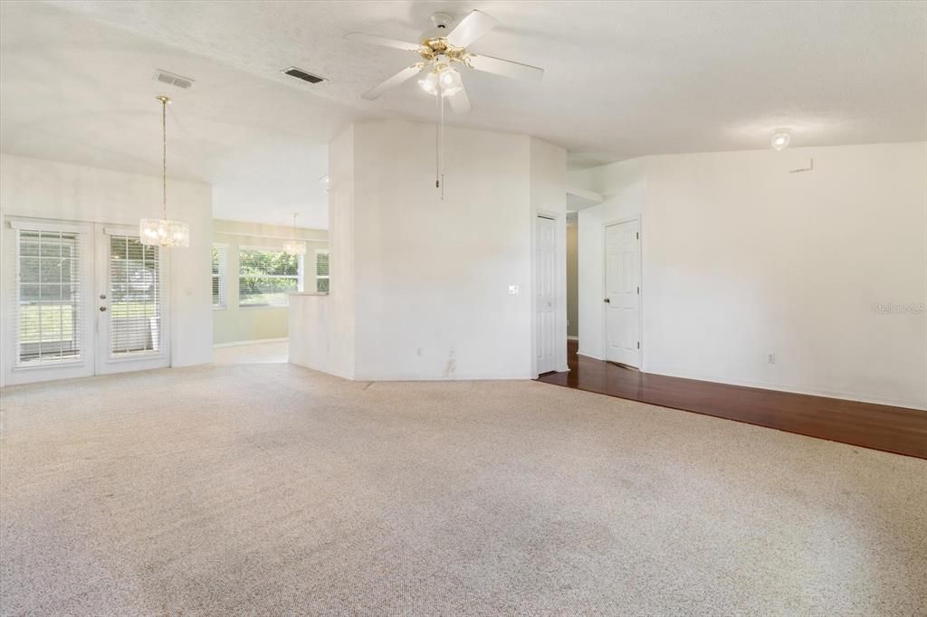 Living Room/Dining Room Combo... Vaulted Ceilings and French Doors Leading to the Covered, Screened Lanai