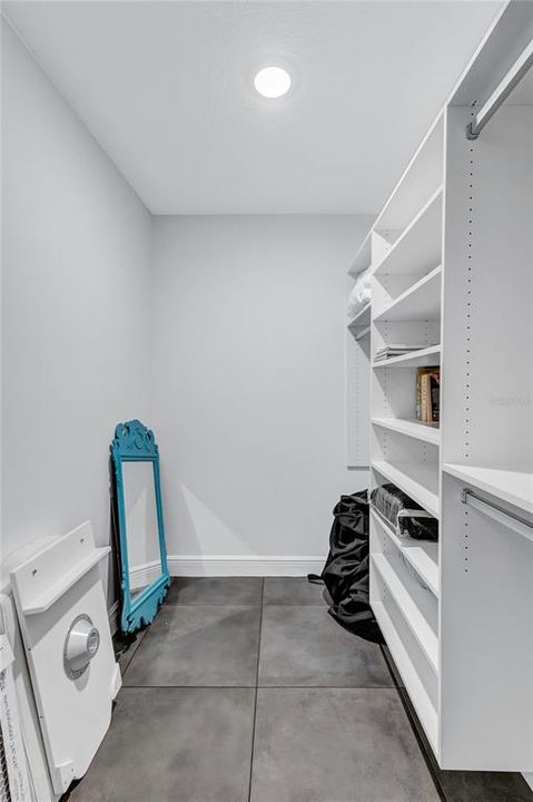 Large walk in closet with complete with California Closet system