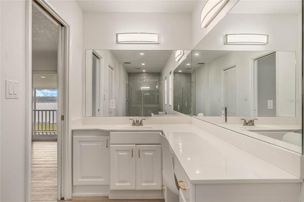 Ensuite master bathroom with large vanity and laundry shoot