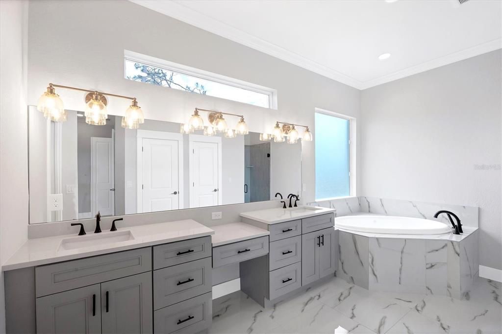 Master Bath is complimented by Quartz counters, dual vanities with make up counter & a jetted tub