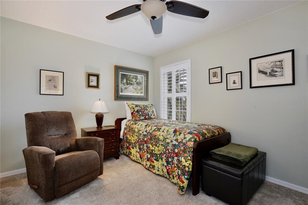 Bedroom 3, custom plantation shutters, ceiling fan.