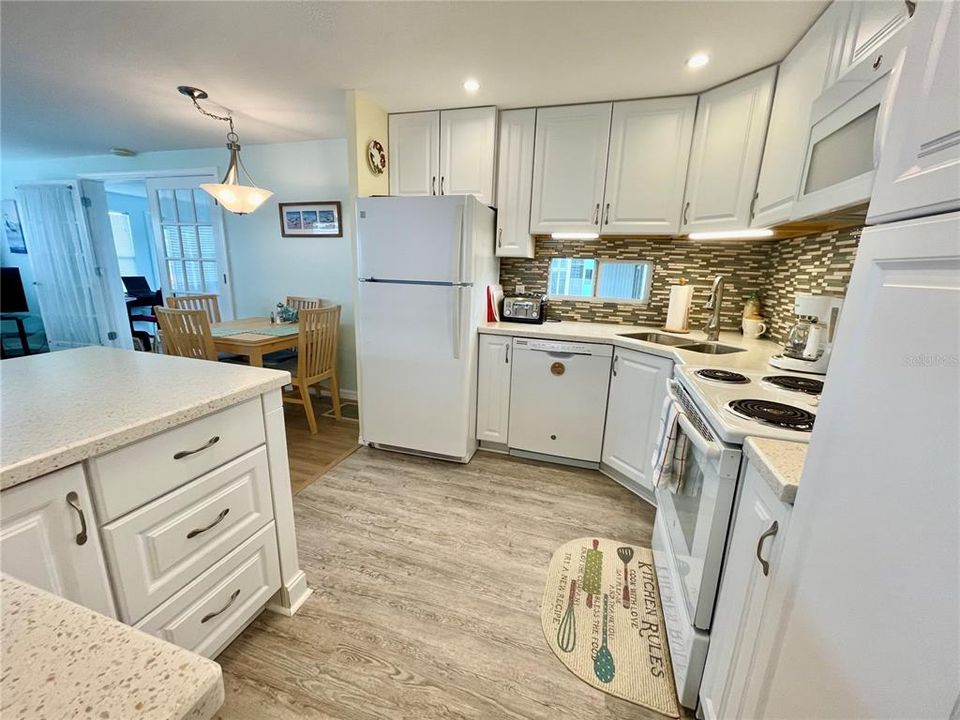 Beautiful kitchen remodel, solid surface countertops, wood cabinets, back splash, Luxury vinyl plank flooring, etc.... AND a dishwasher!