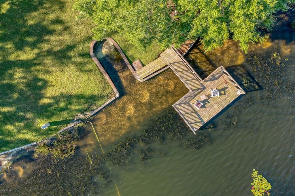 Enjoy the lakefront lifestyle with this spacious dock for fishing and protected jet ski slip.