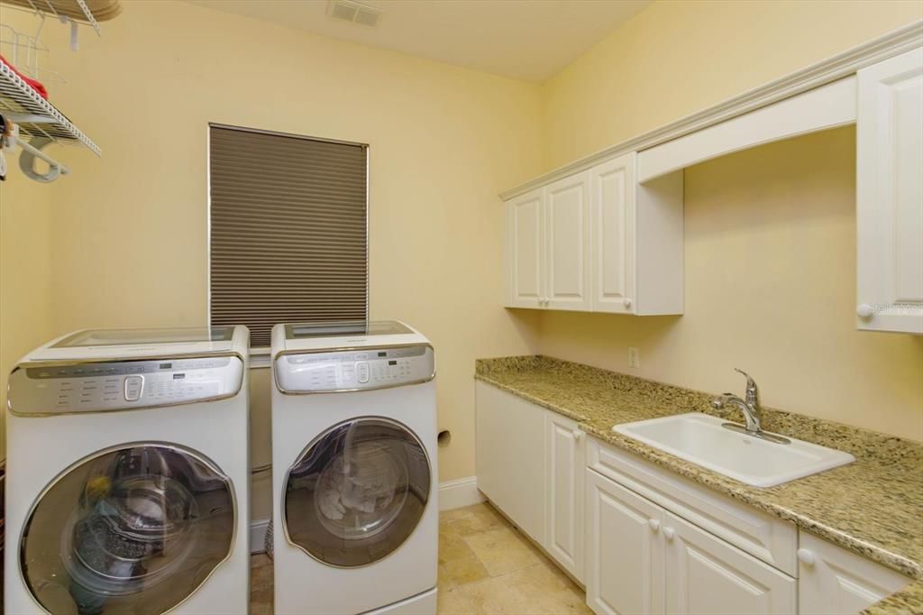 Downstairs laundry room with granite counters and lots of storage