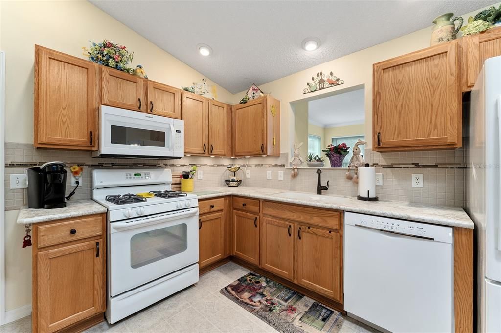 KITCHEN features GAS COOKING and PASS THROUGH WINDOW to FLORIDA ROOM.