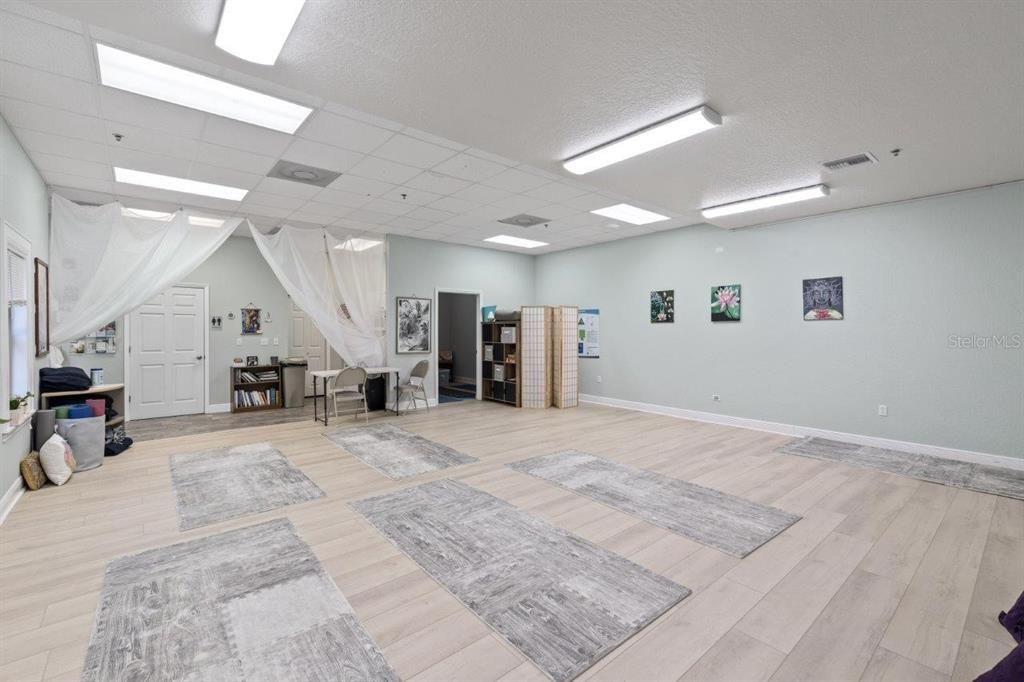 Main 25'x24' studio space featuring high ceilings and several large windows.