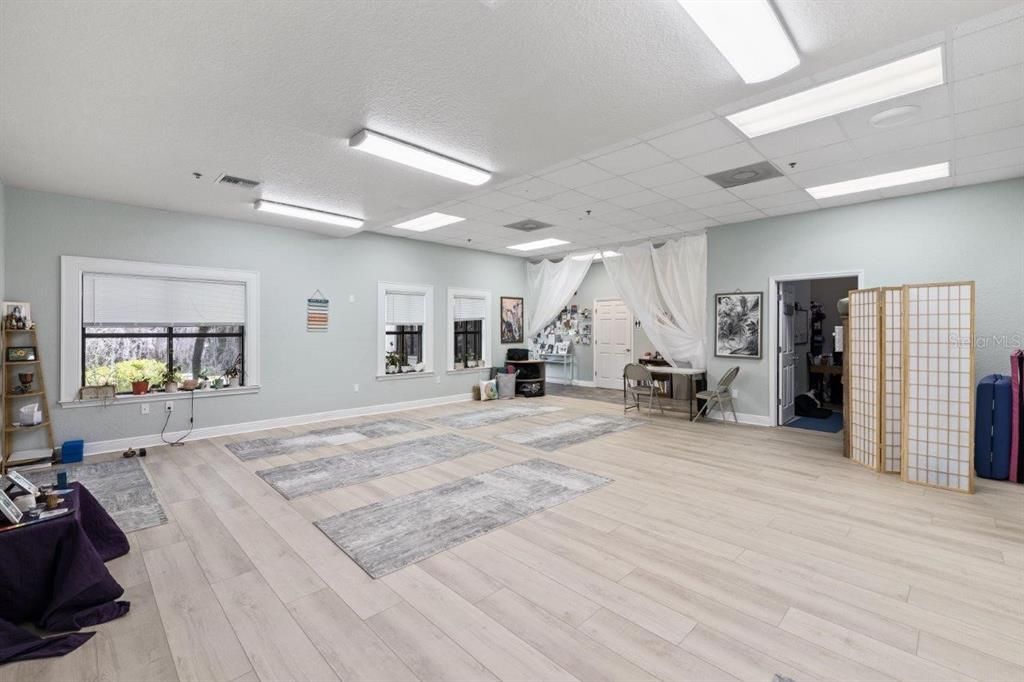 Main 25'x24' studio space featuring high ceilings and several large windows.