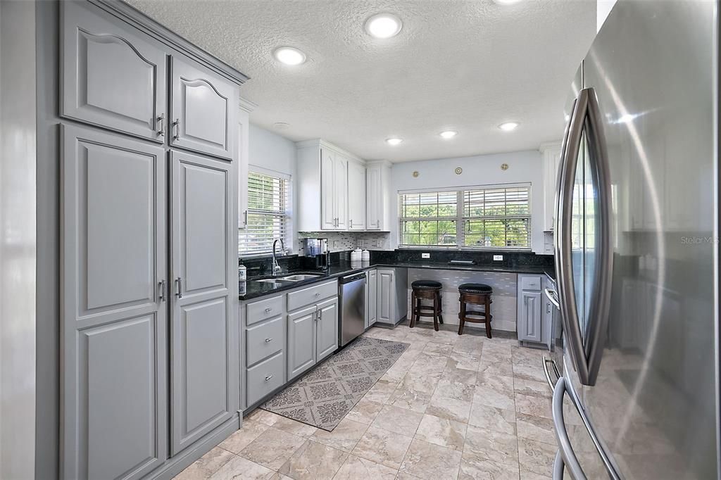Wonderful kitchen, with beautiful tile floors, granite countertops, built in pantry and loads of natural light!
