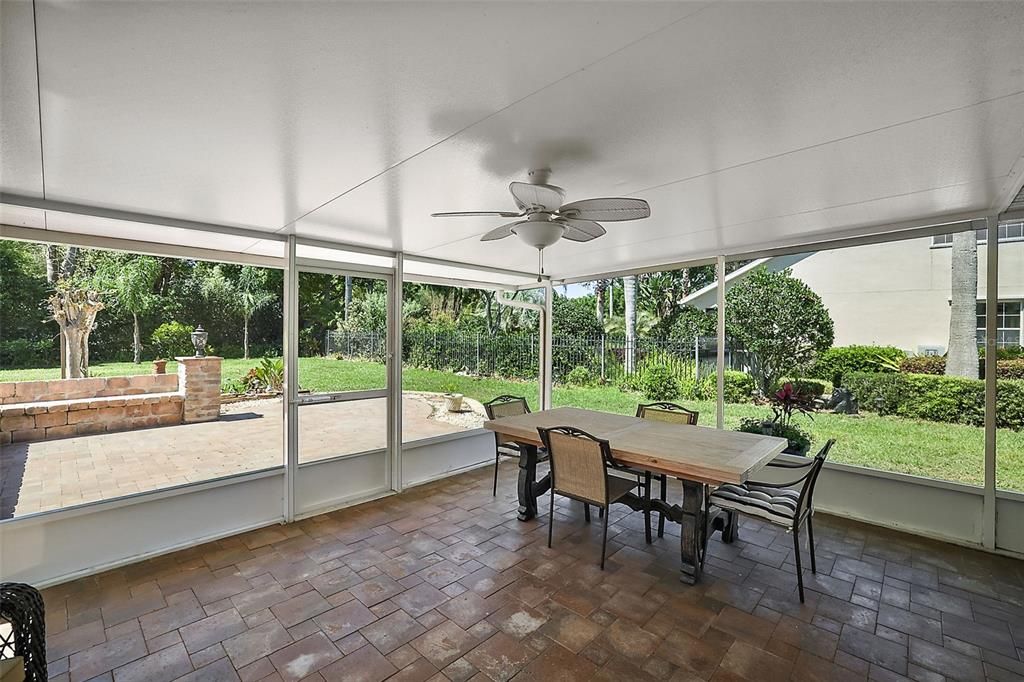 Enclosed Florida room leads you to the screened lanai, with brick paver floor