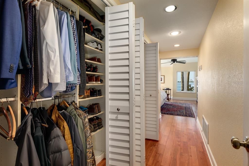 His wall of built-in closets with organizers