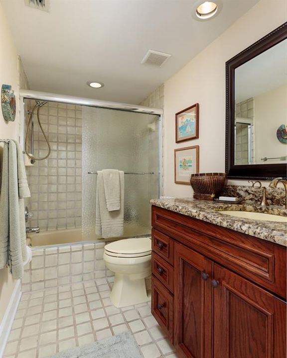 Ensuite bath in guest bedroom serves as pool bath