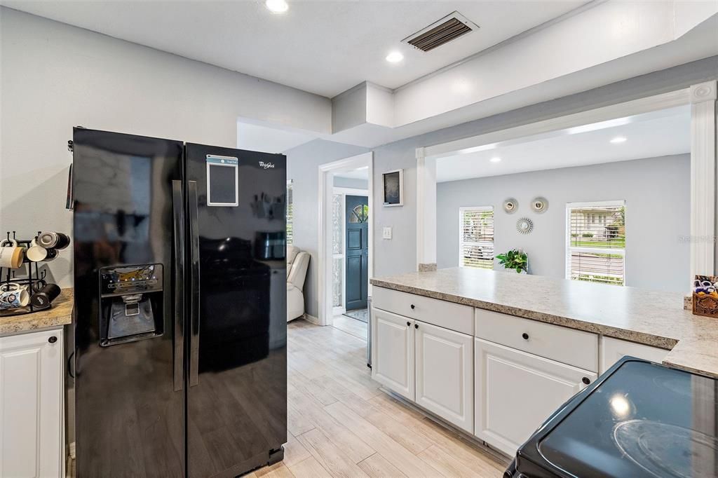 A large breakfast bar provides excellent meal preparation space, a place to grab a quick bite or gather with friends and family