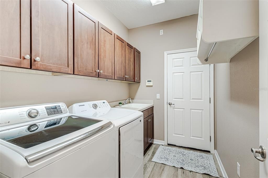 Laundry room with sink and storage