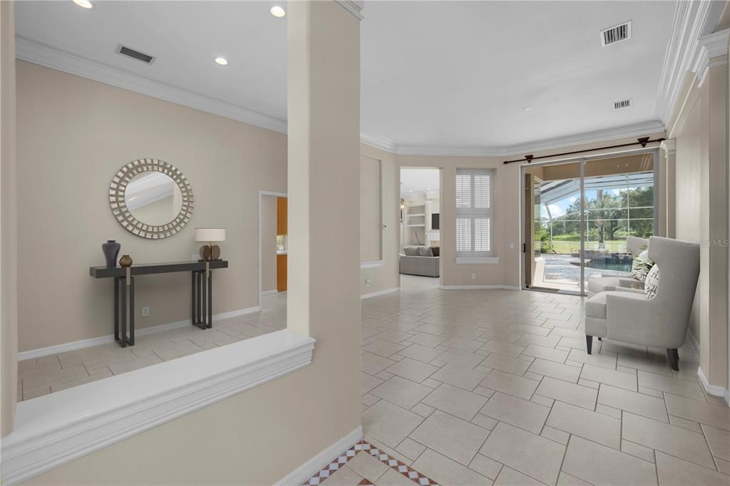 STAGED - Foyer, dining room, liv. room looking toward pool/large covered lanai