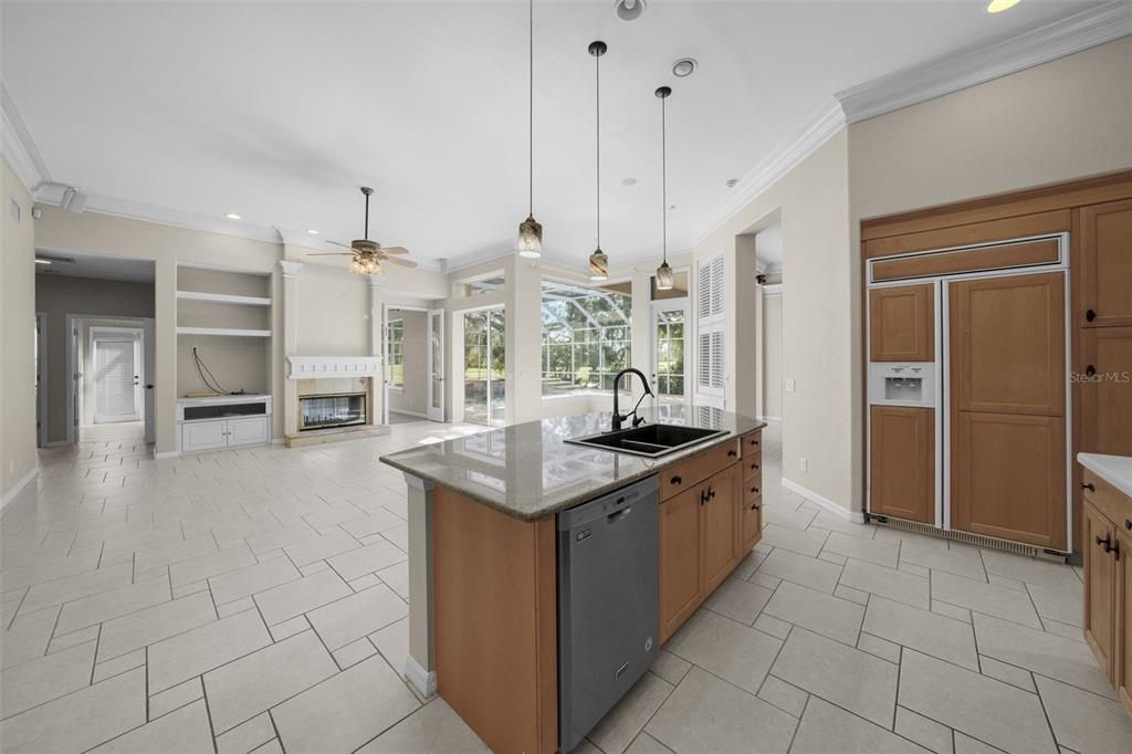 View of kitchen to family room and pool area - and BR 4/pool bath, downstairs office/bonus room