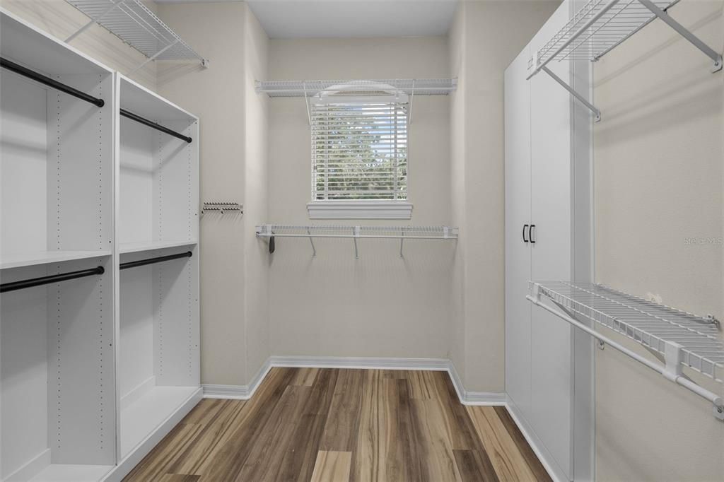 Large walk-in master closet with built-in shelving