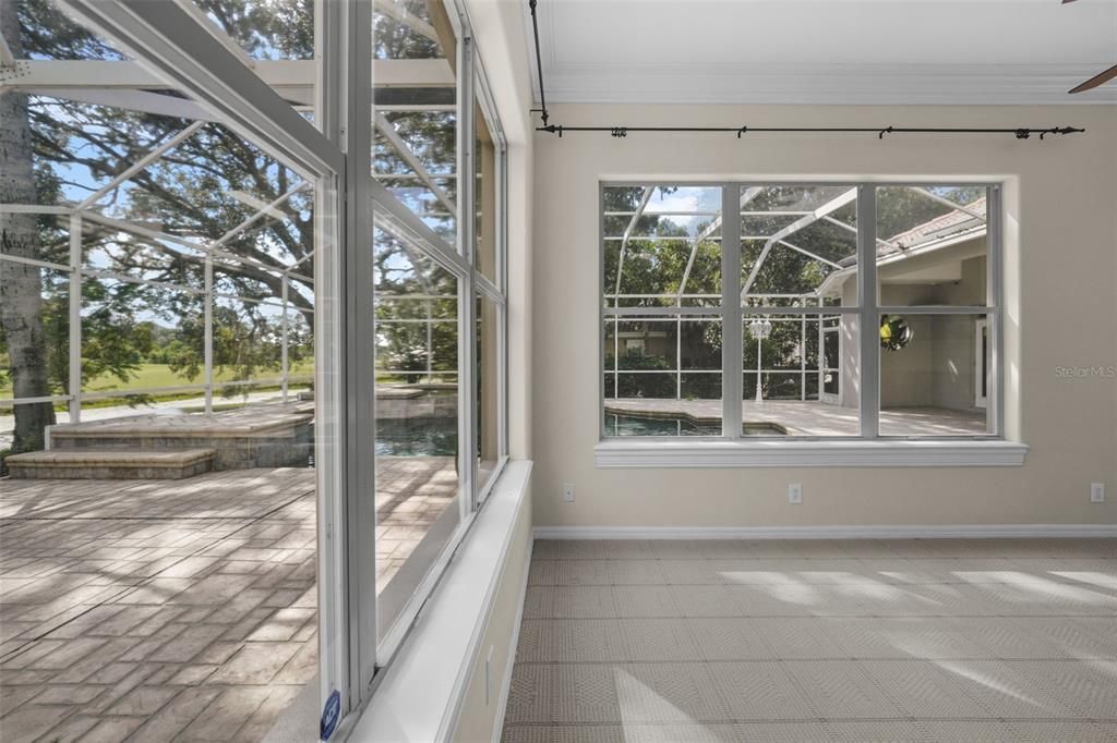 Another view of downstairs home office/bonus room  looking toward pool/heated spa/golf course/with outdoor bar to left.