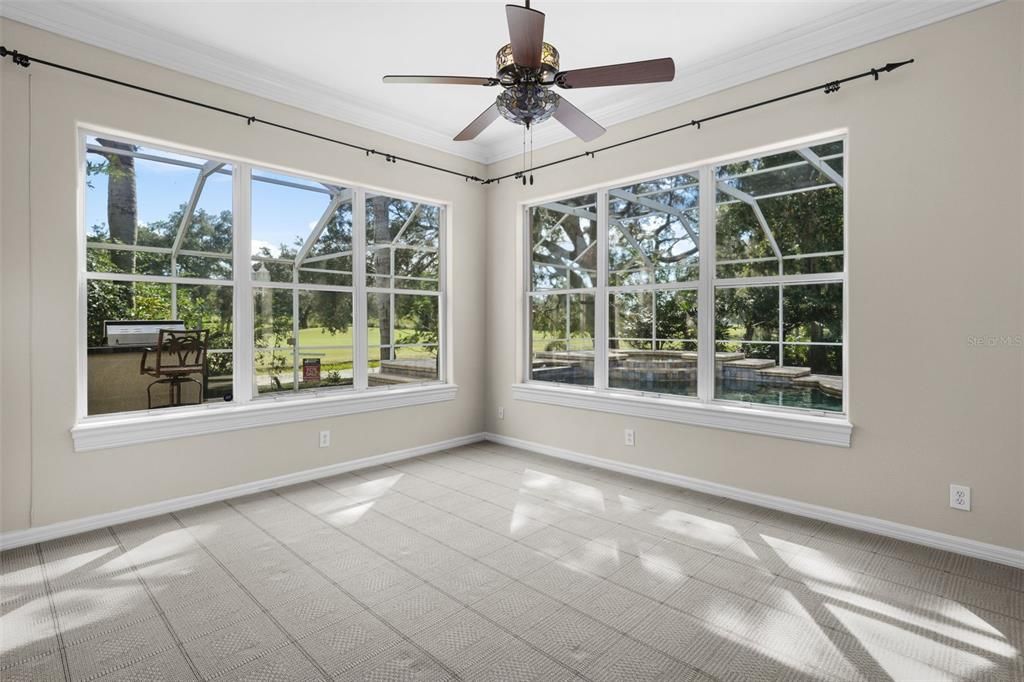 Downstairs home office or add'l bonus room/bar room -- view of golf course and pool from here.  Owner used as a private bar with game table