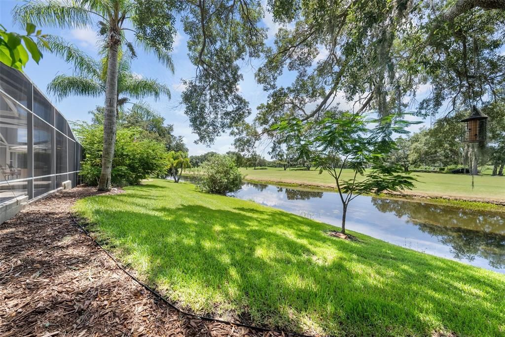 Backyard of home with water/golf course view.