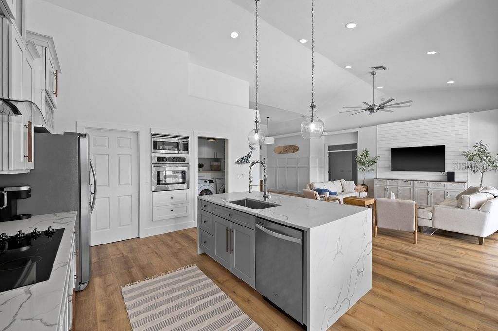 Lots of room in this kitchen. Stainless steel appliances.