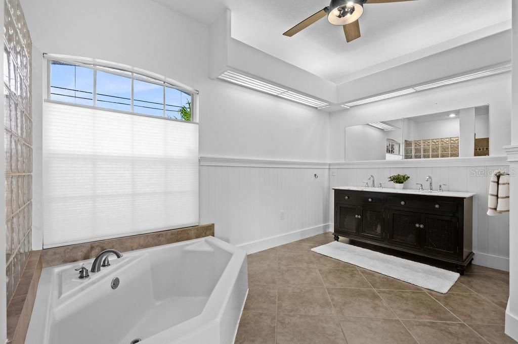 Master Bathroom with dual sinks, tub and separate shower