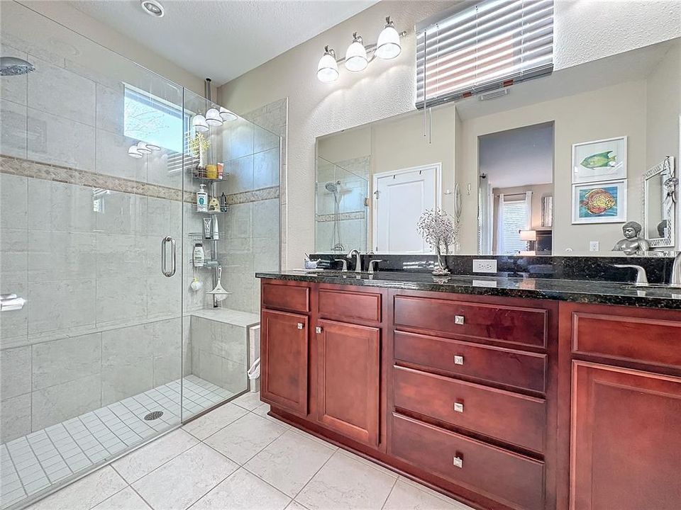 PRIVATE PRIMARY BATHROOM features DUAL ELEVATED SINKS, TILED SHOWER with LISTELLO,