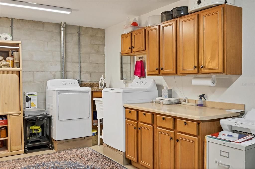 Laundry Area In Garage With Built In Cabinets
