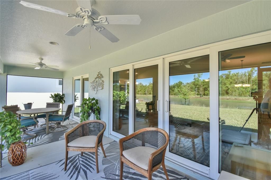 Expansive sliders open to lanai with water view