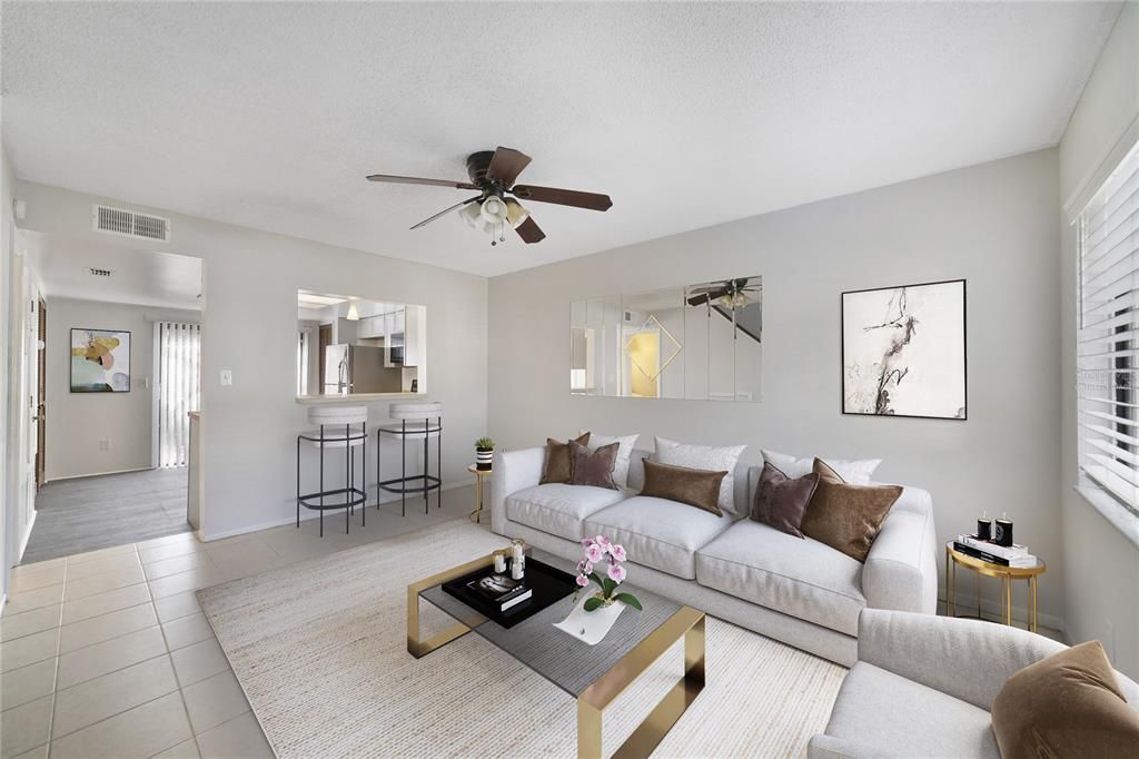 The comfortable living area is connected to the refreshed EAT-IN KITCHEN via a passthrough breakfast bar with STAINLESS STEEL APPLIANCES, a closet pantry for additional storage and SLIDING GLASS DOOR access to a patio that provides beautiful NATURAL LIGHT. Virtually Staged.