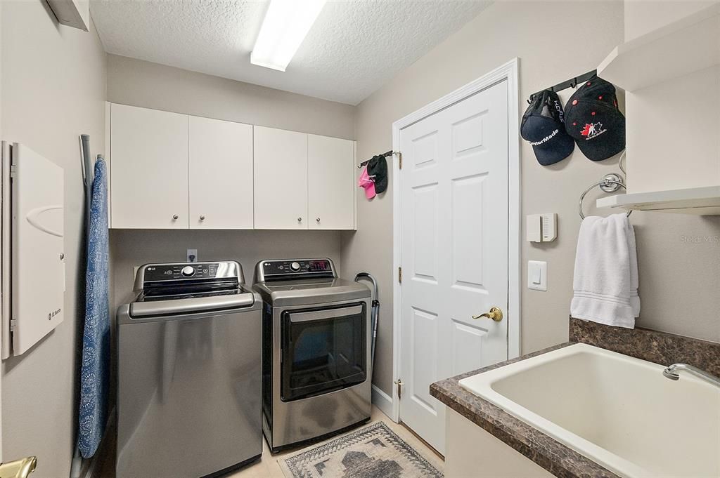 Laundry Room w/Sink, Storage Cabinets & Door to Garage