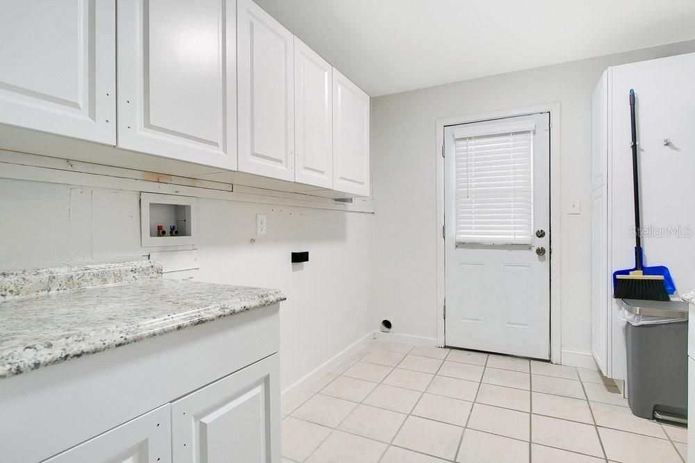 Inside laundry room off the kitchen with plenty of storage!