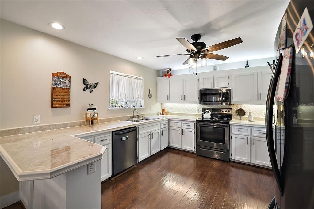 Kitchen has Tiled Granite Counters and newer Stainless Appliances.
