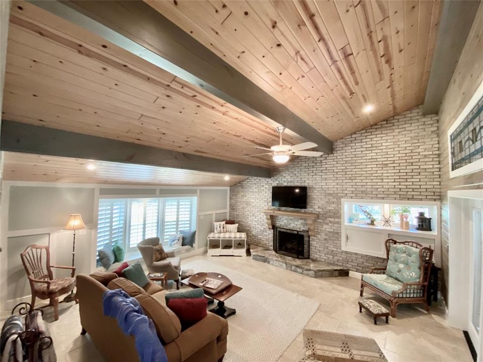 Family Room with tile and tongue and groove ceiling and wood beams